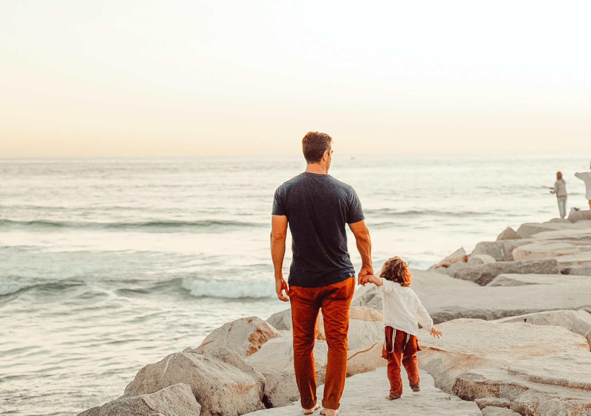 father and son walking on beach