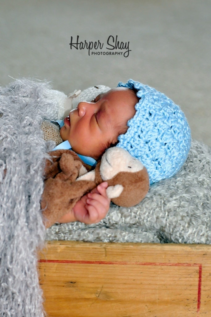 sleeping baby with toy monkey