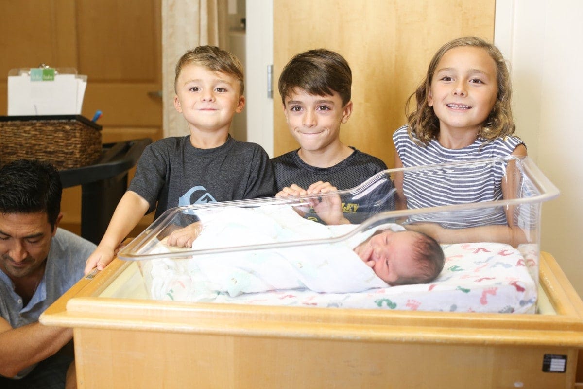 kids with newborn baby