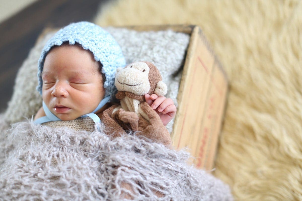 infant with monkey toy