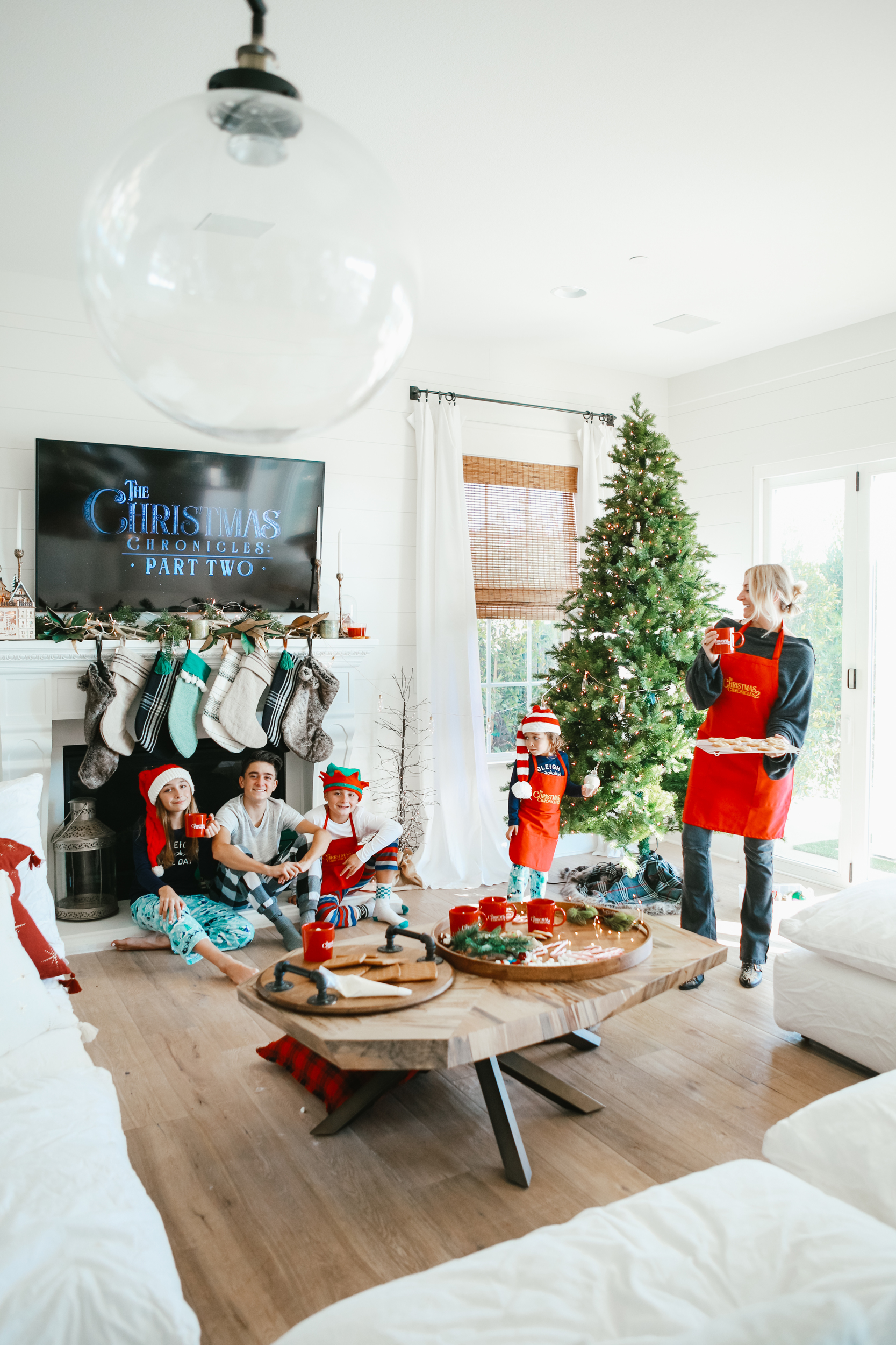 family in living room with christmas tree