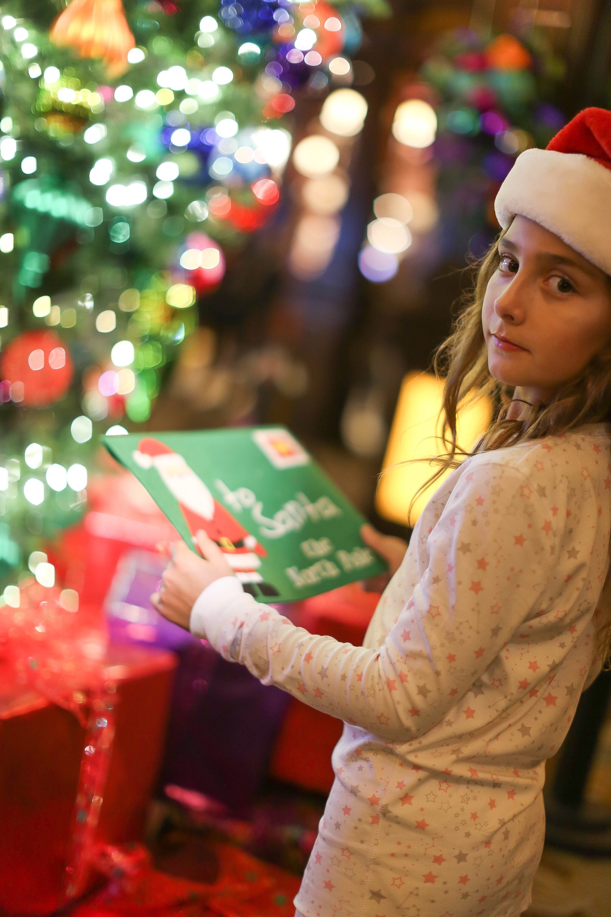 girl holding letter to santa