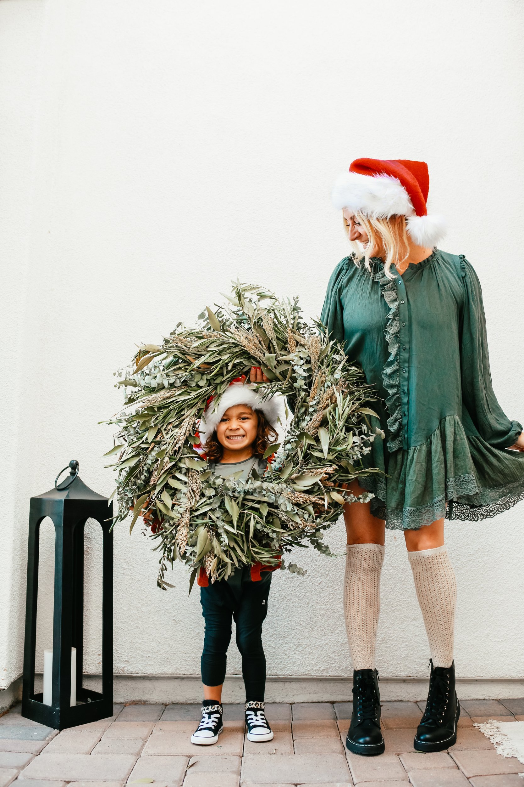 mom with toddler and christmas wreath