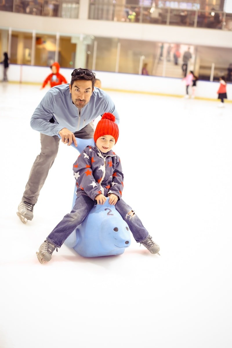 dad and son ice skating 