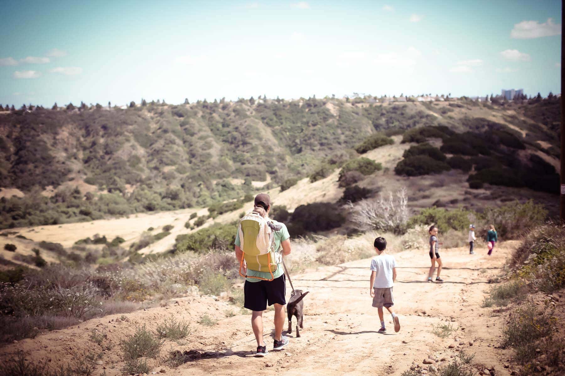 father with dog and kids