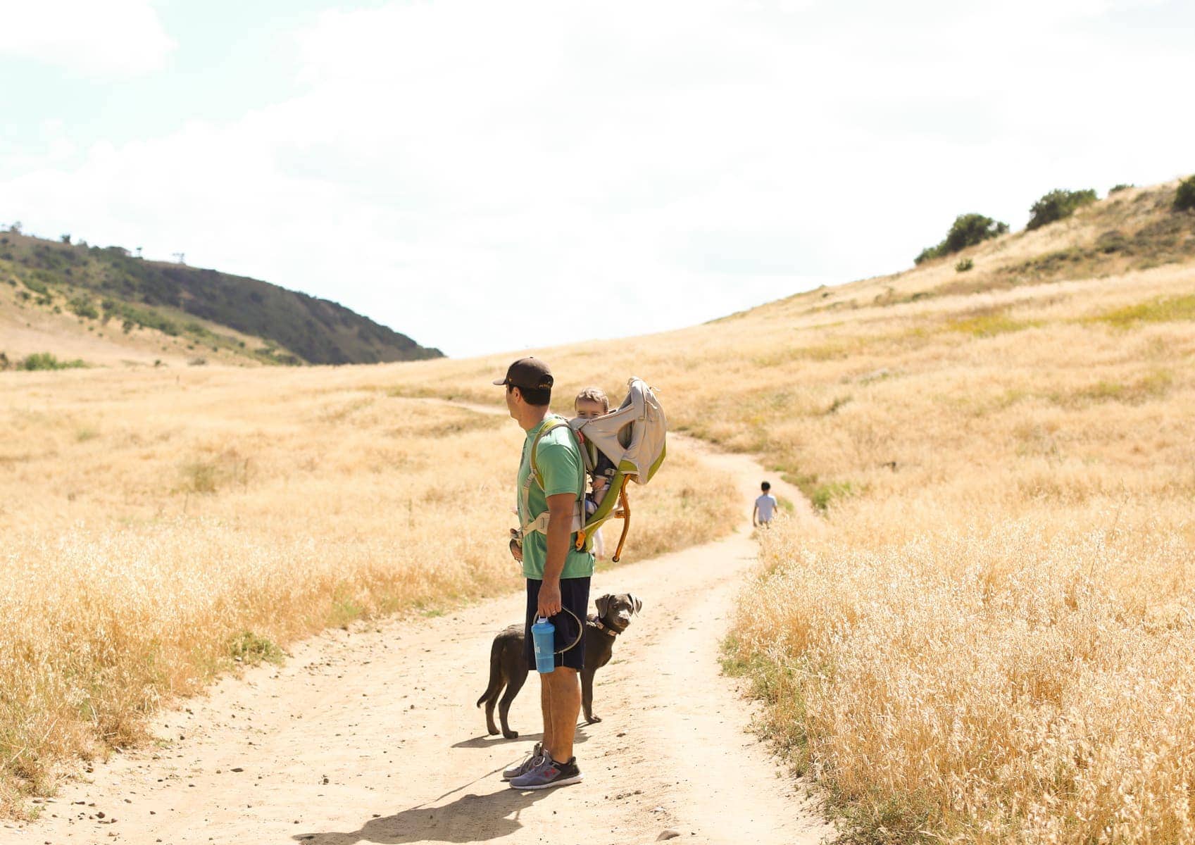 man with baby and dog