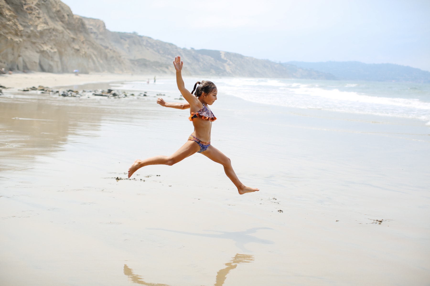 girl jumping on the beach