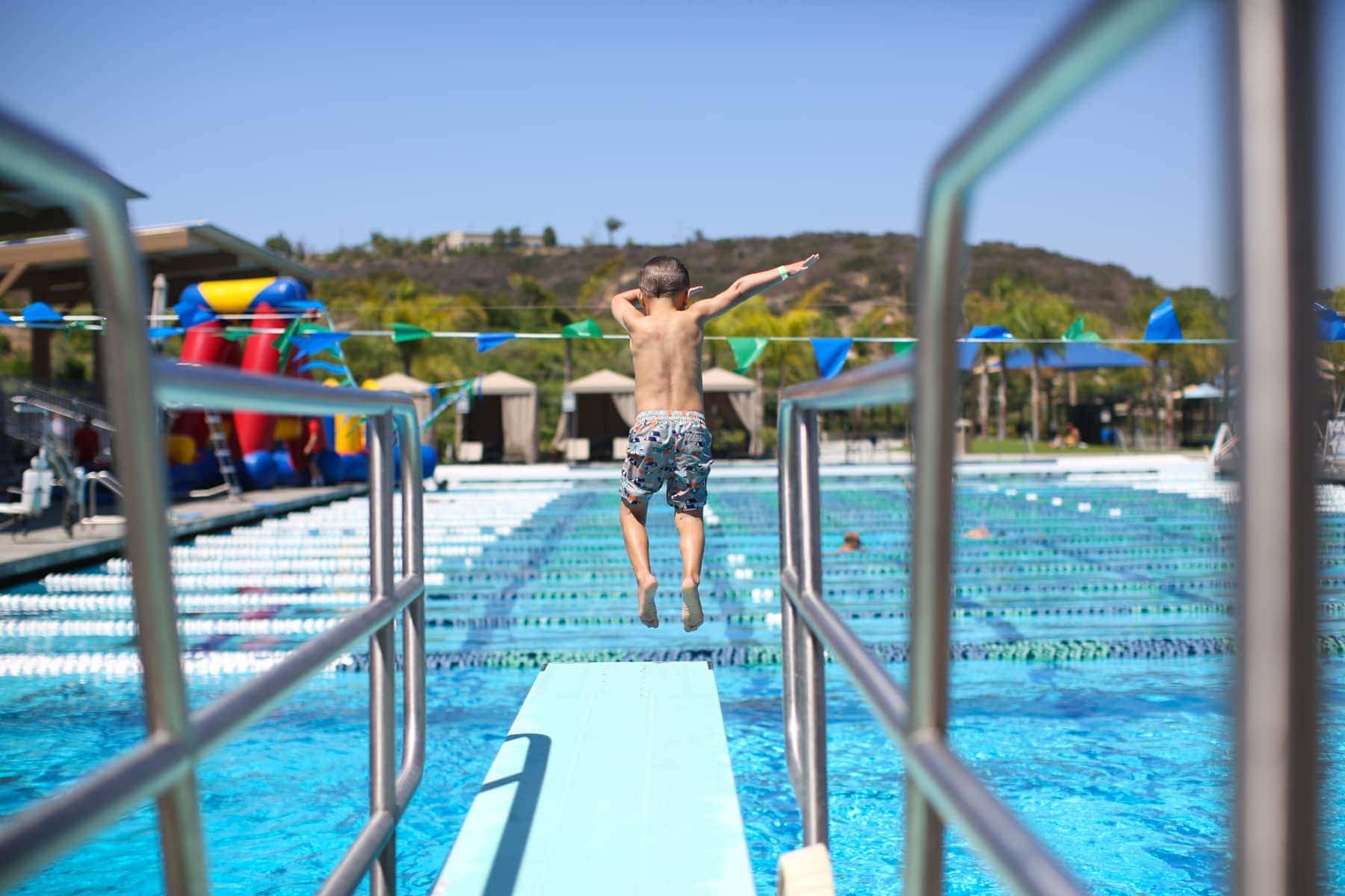boy jumping off diving board