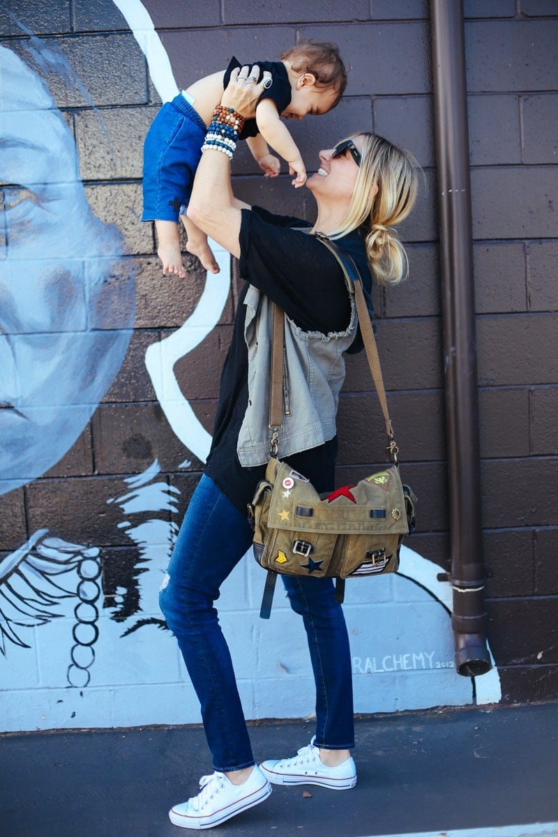 mom holding up baby