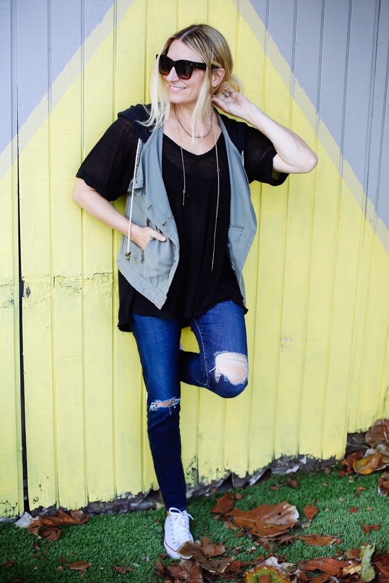 stylish woman leaning on wall