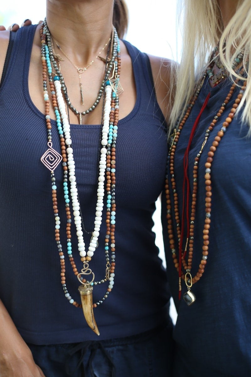 women in layered necklaces