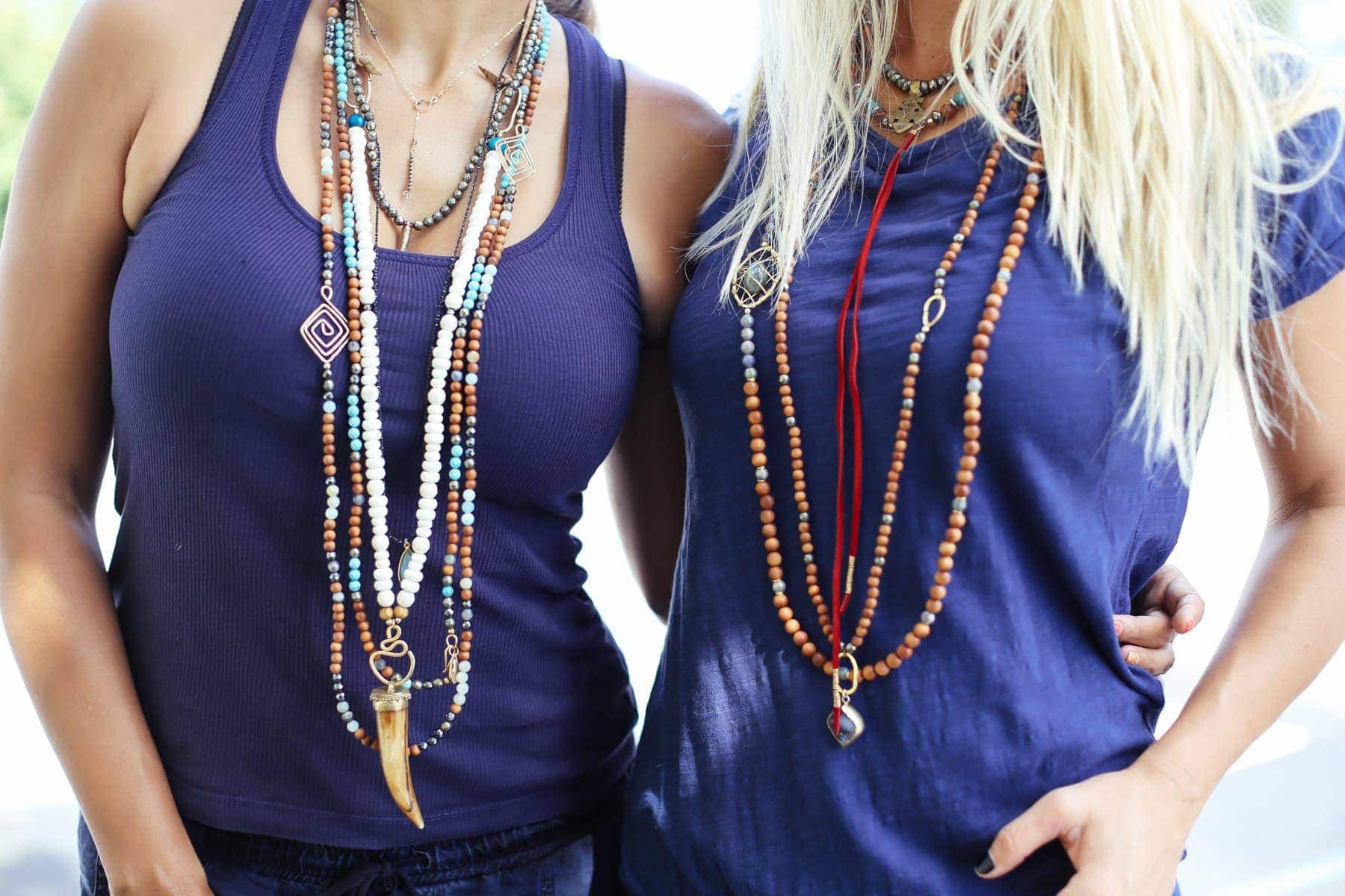 women in layered necklaces