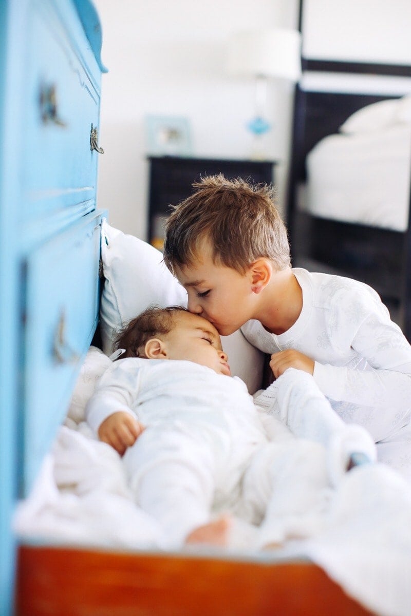 boy kissing baby brother
