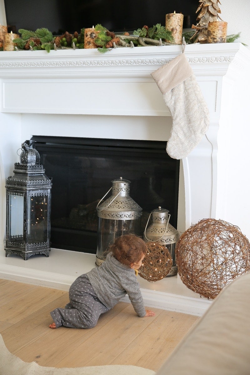 baby by fireplace decor