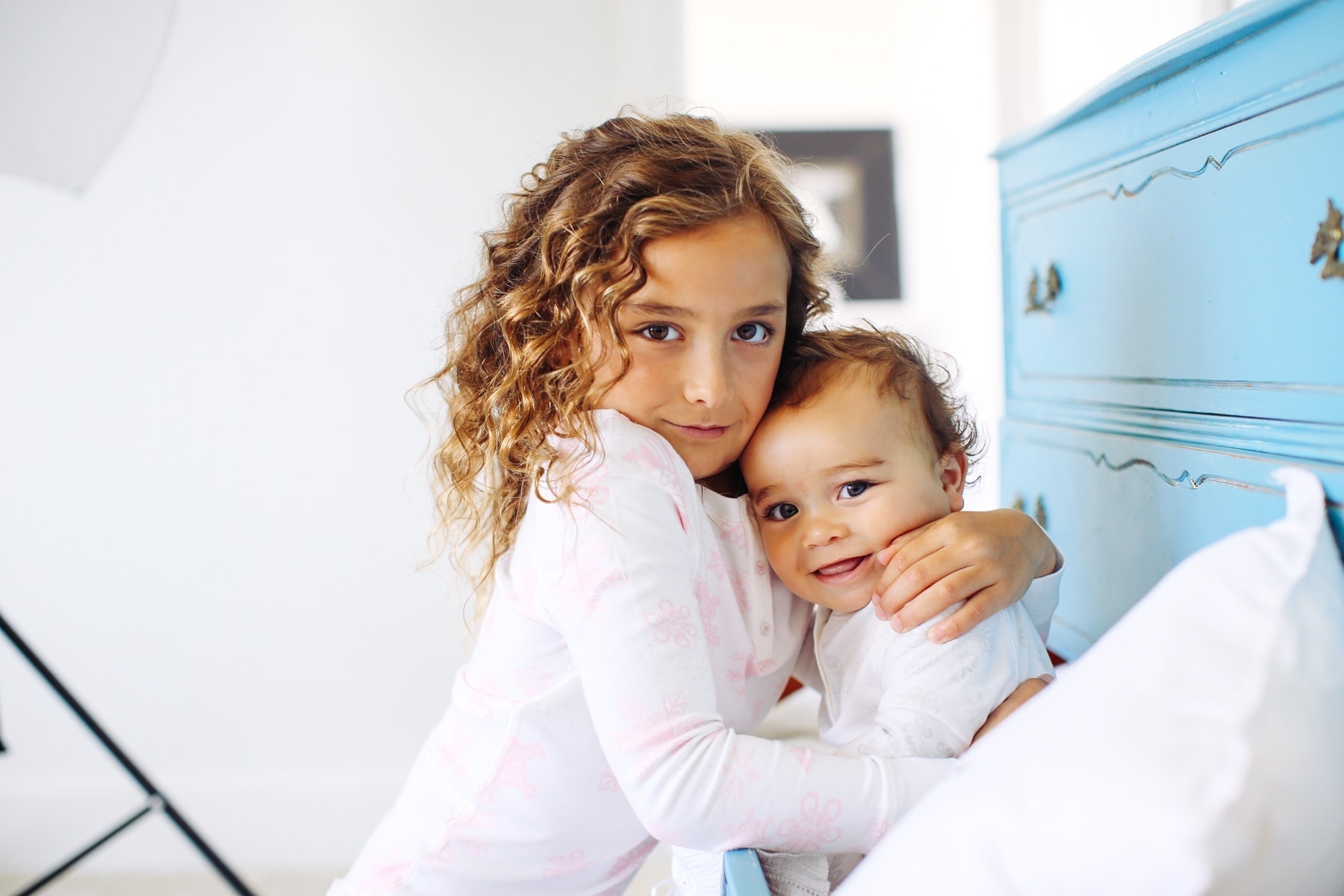 girl and baby hugging