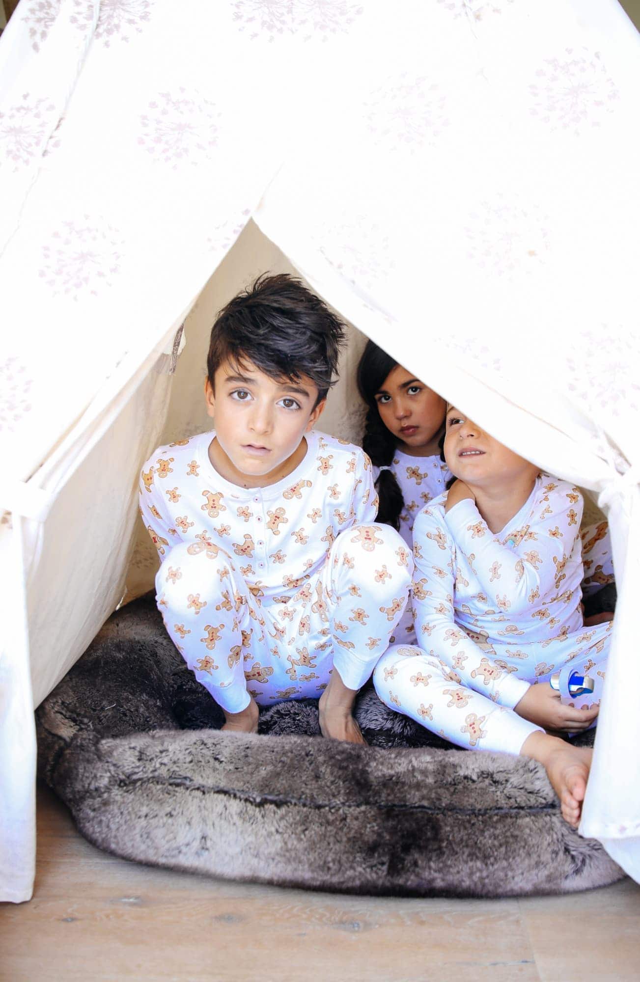 kids in tent with christmas pajamas