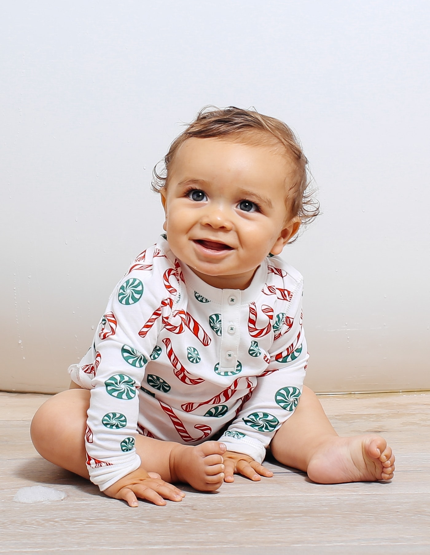 smiling baby with christmas pajamas