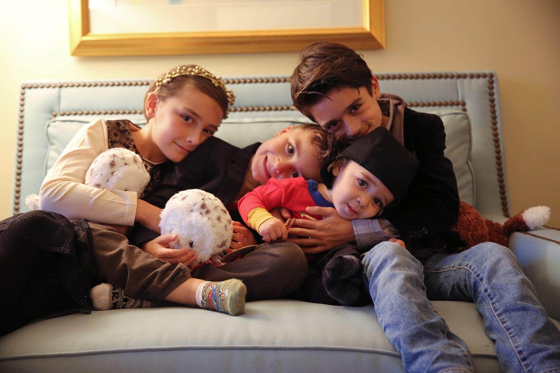 children cuddling on couch