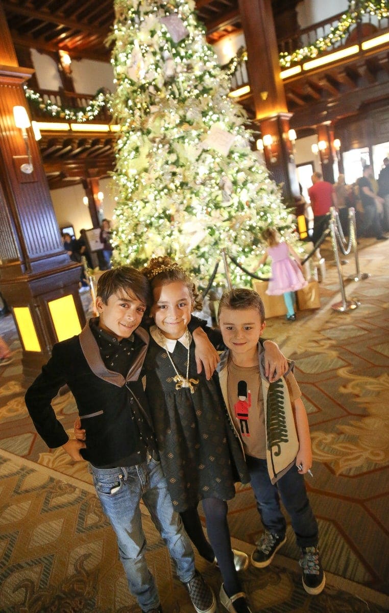 children by christmas tree