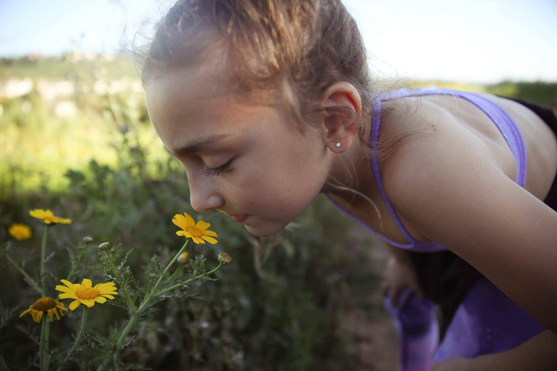 girl smelling flowers 