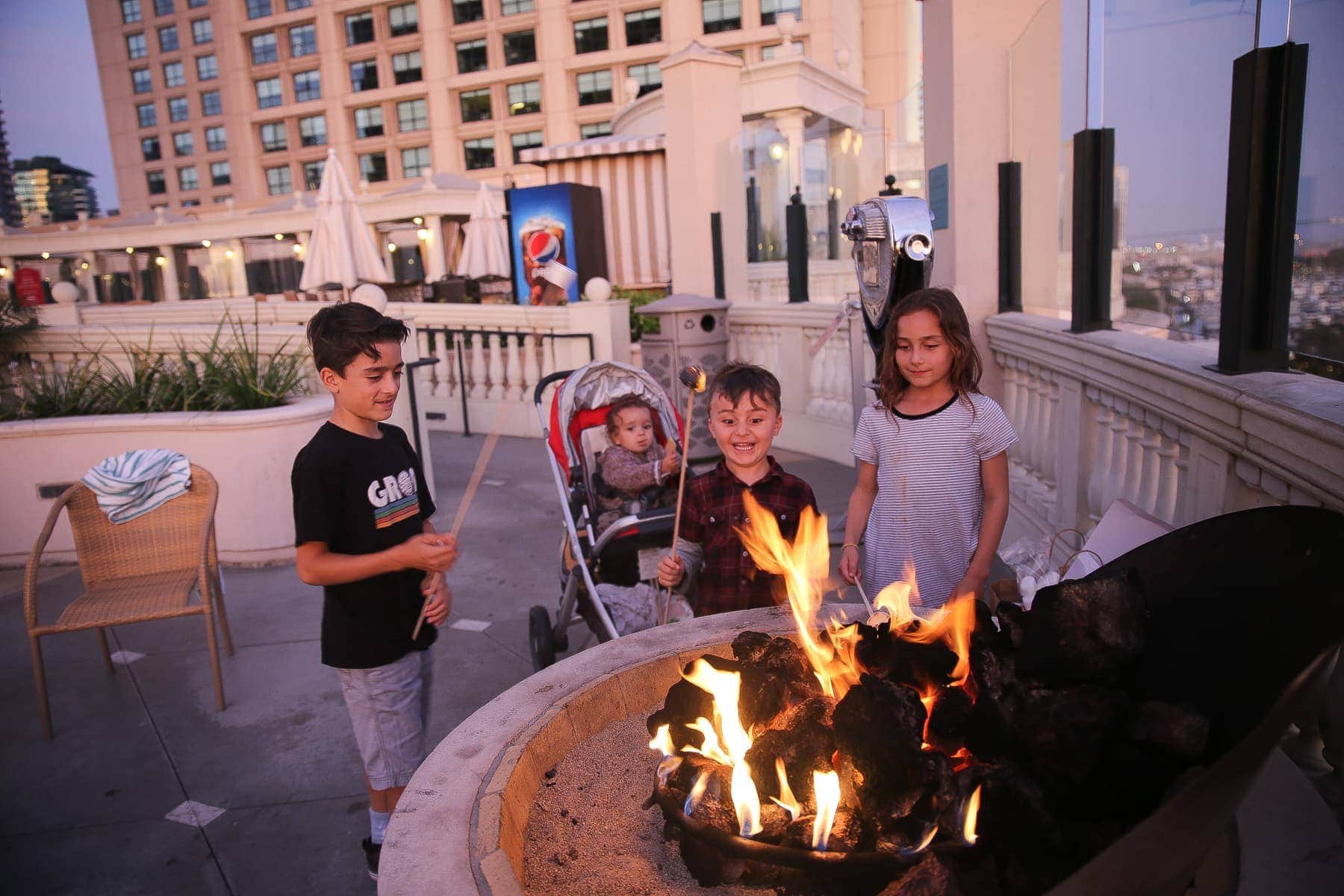 kids making s'mores on the rooftop