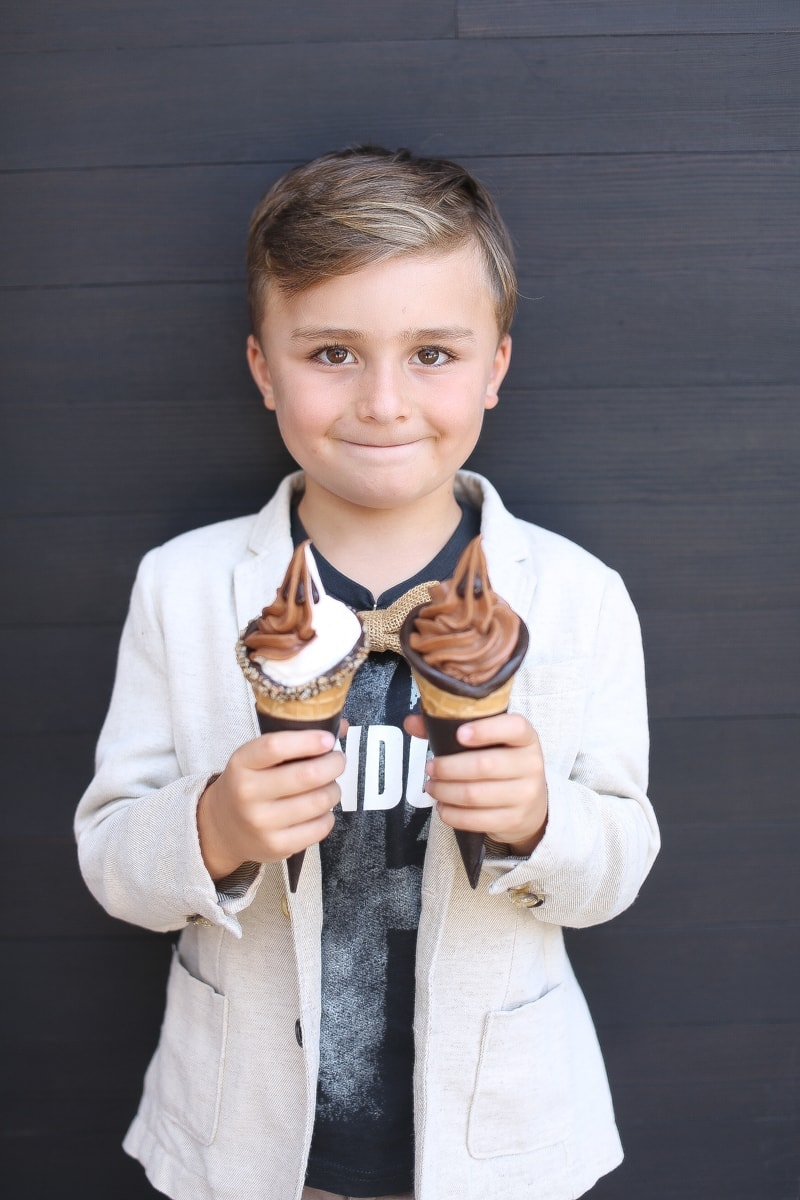 boy holding ice cream cones