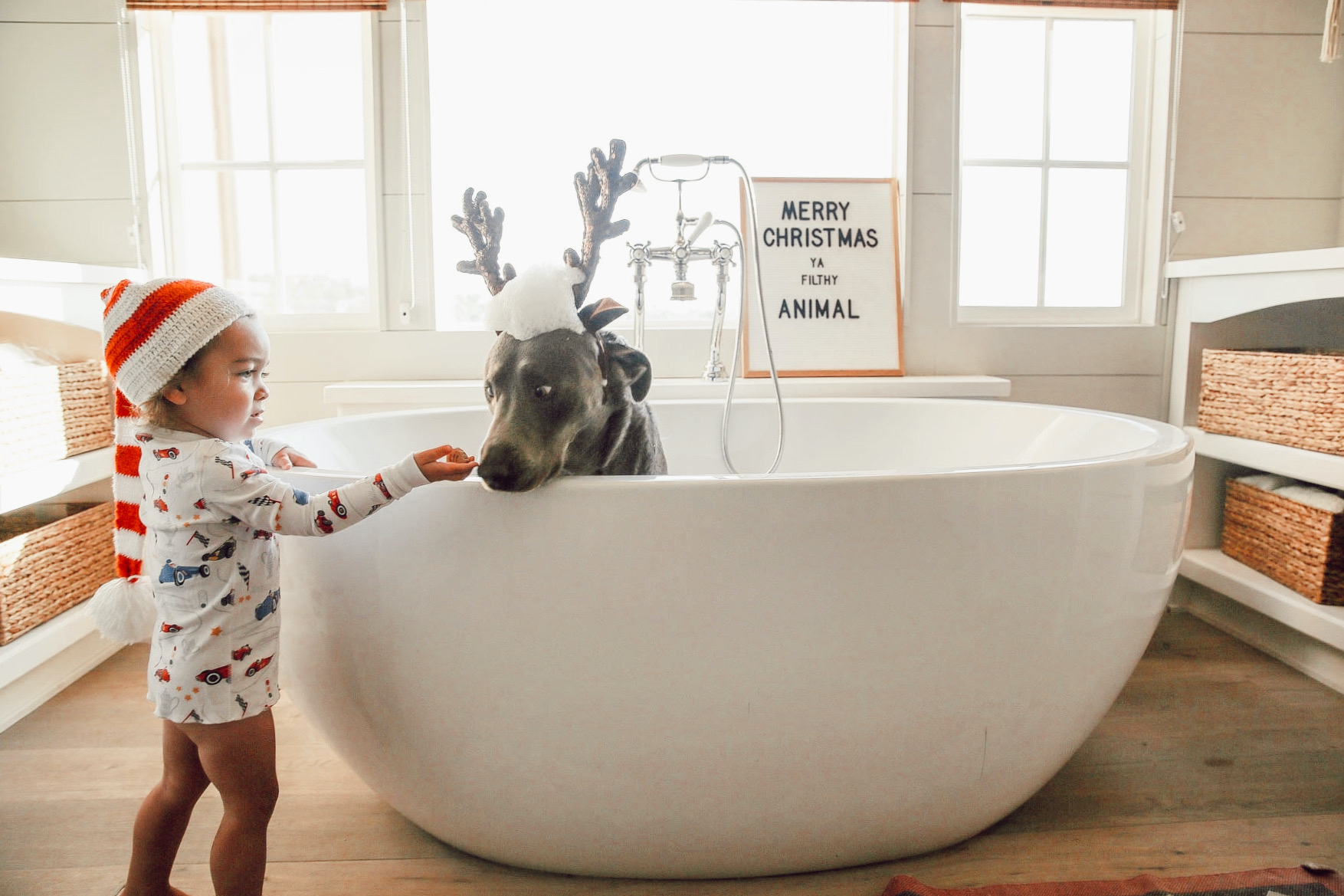 baby and dog in bathtub