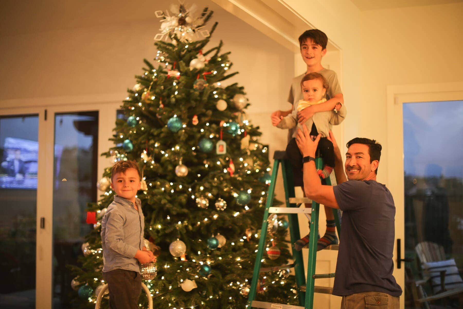 Daddy and boys decorating the Christmas tree