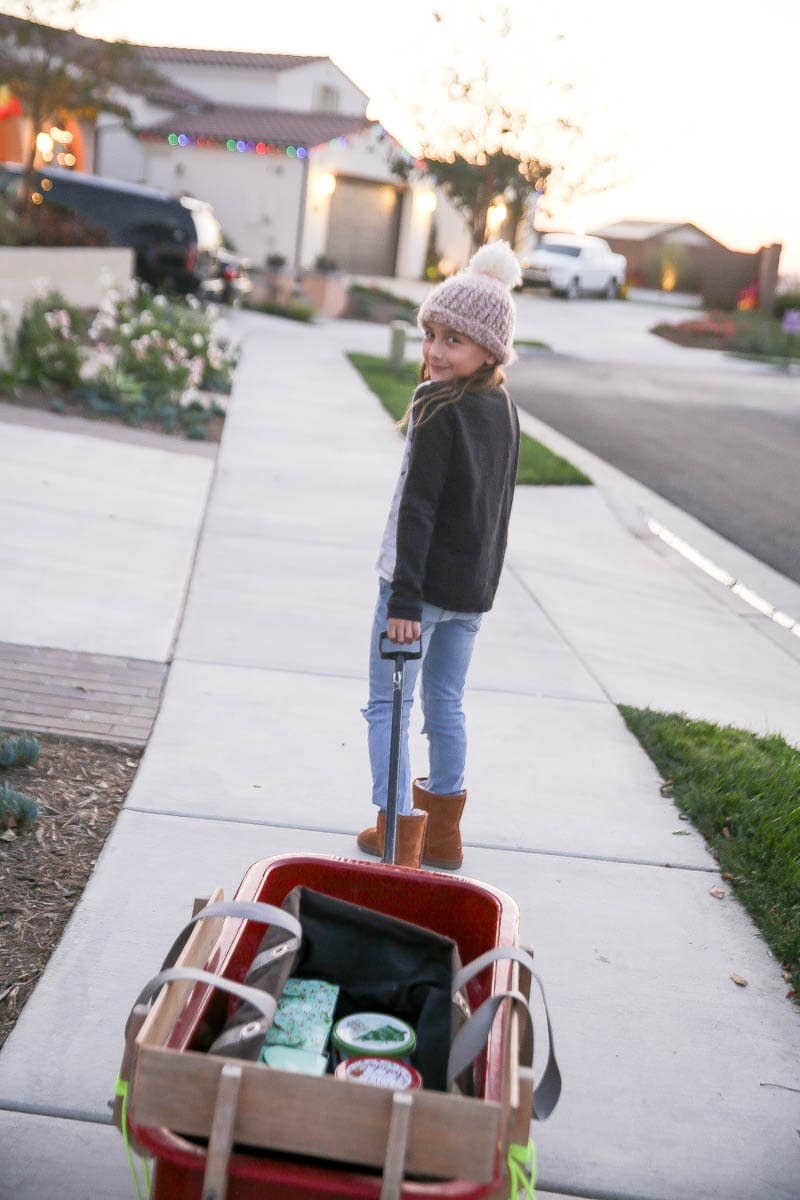 girl pulling red wagon 