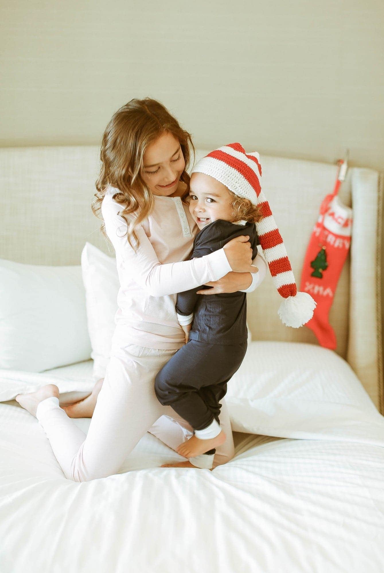 christmas siblings on bed