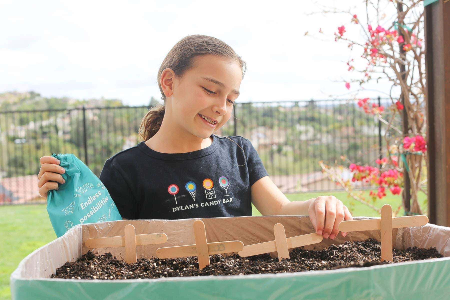 Girl arranging the labels on the Boxed mini garden