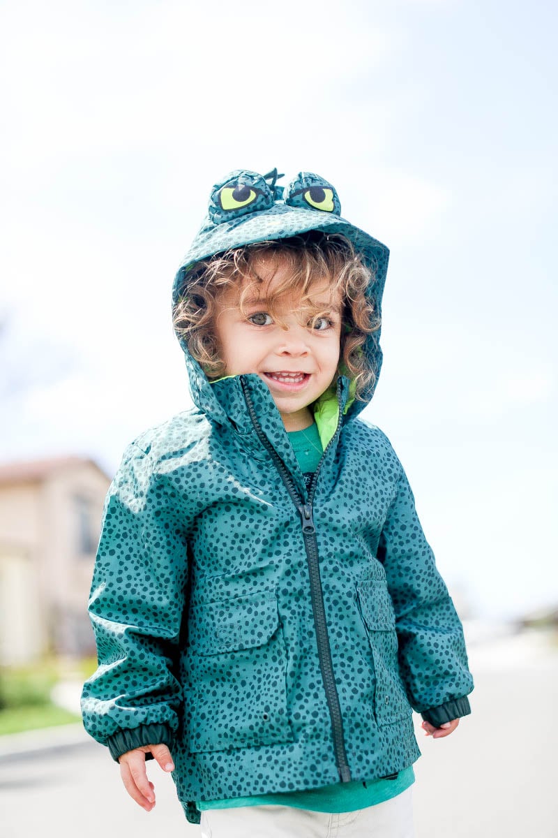 happy toddler in raincoat