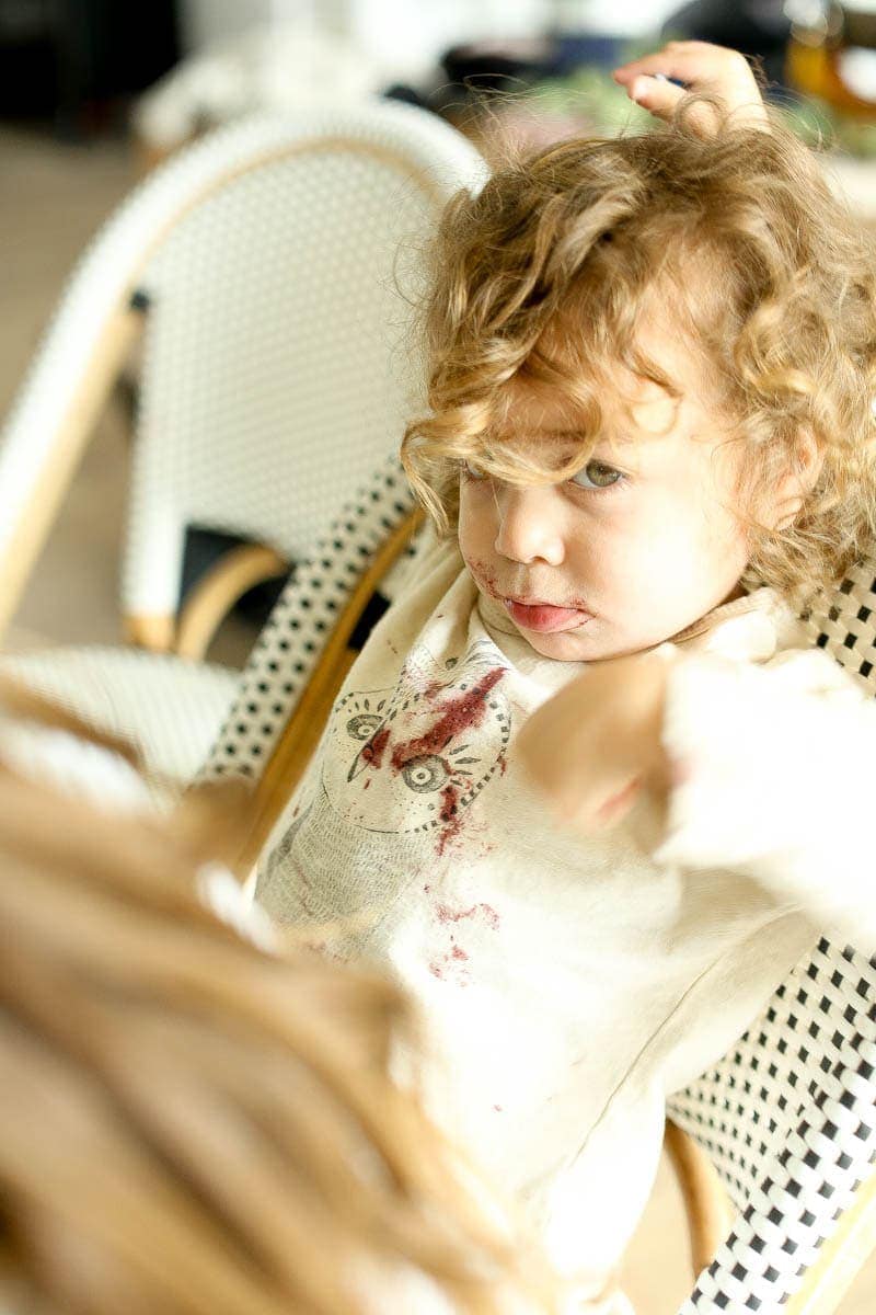 unhappy toddler sitting in chair