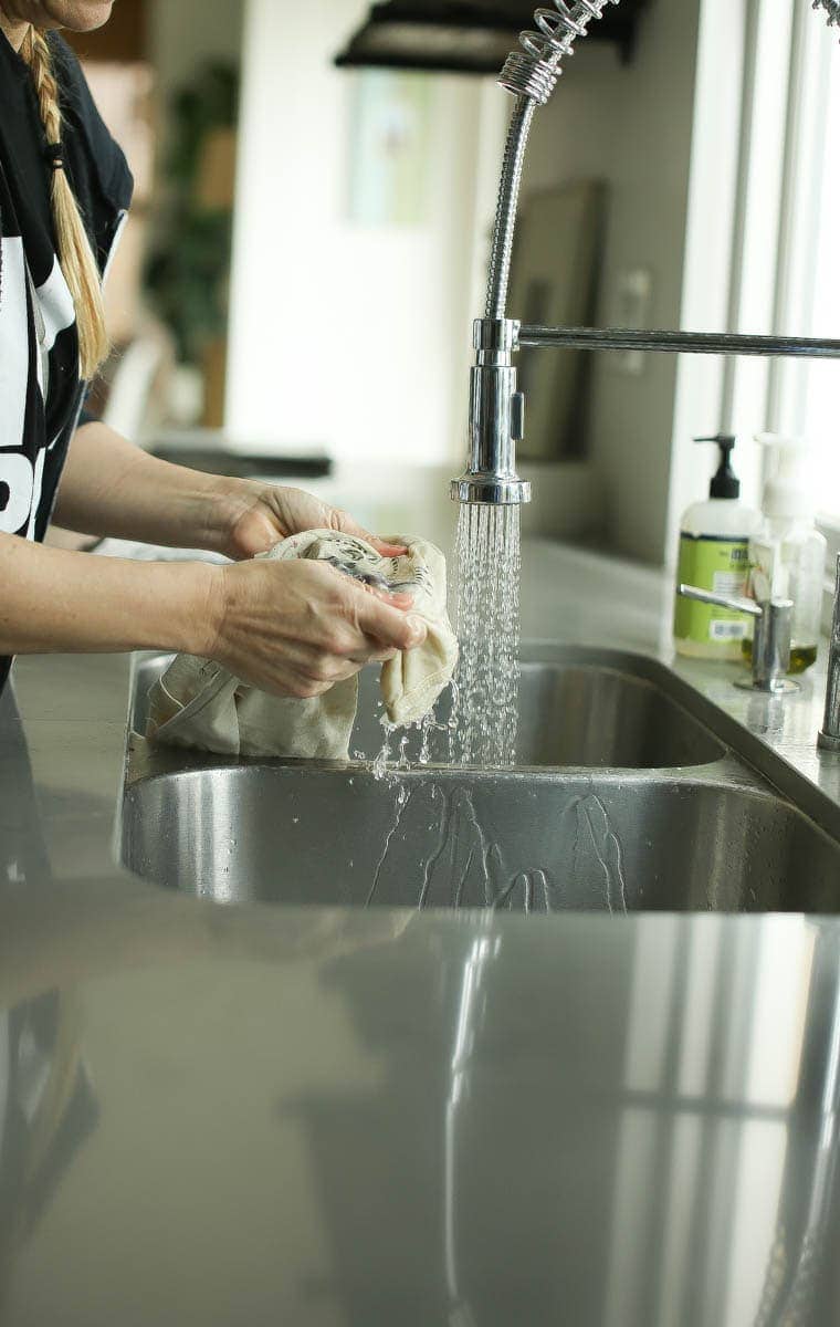 woman washing clothes in the sink