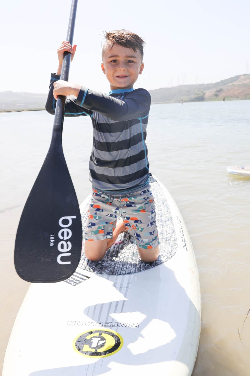 Kid Smiling While on Paddle Board #familytravelsandiego #sandiego #fourseasonsresidenceclub #bigfamilytravel 