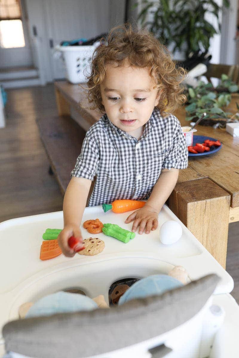 Kid Giving Foods to Baby Dolls