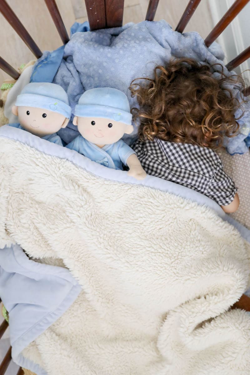 Kid Sleeping with Baby Dolls