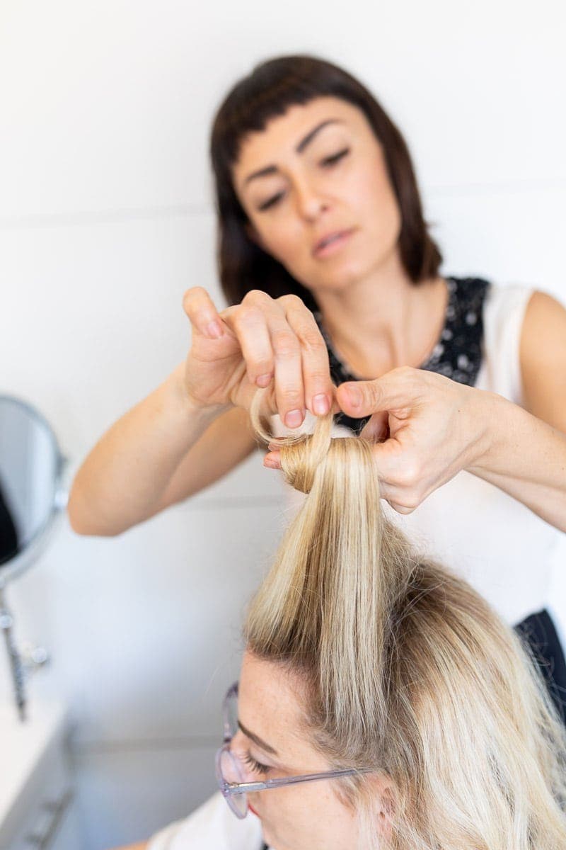 Step 4: Hair Stylist Rolling Strands of Hair around the Fingers #pinuptutorial #vintagehairstyle #hairstyle #citygirlgonemom #hairstyle #hairstyling #vintagewaves #vintagelook #hair