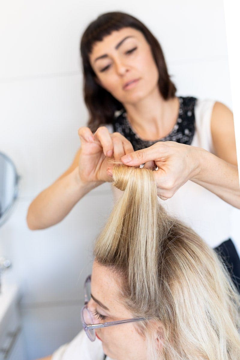 Step 4: Hair Stylist Rolling the Hair around the Fingers #pinuptutorial #vintagehairstyle #hairstyle #citygirlgonemom #hairstyle #hairstyling #vintagewaves #vintagelook #hair