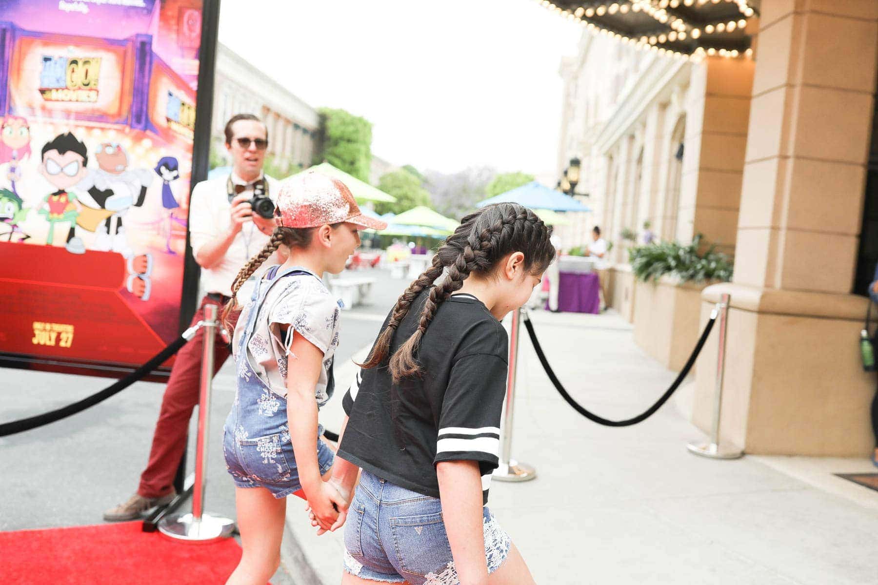 Young Girl Kids Holding Hands While Walking Towards the Theater #hollywood #warnerbrothers #teentitansgotothemovies #citygirlgonemom