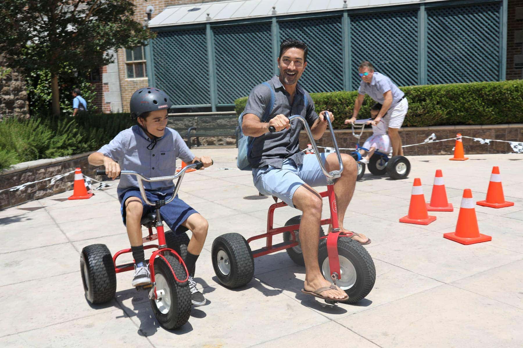 Father and Son Riding tricycles #hollywood #warnerbrothers #teentitansgotothemovies #citygirlgonemom