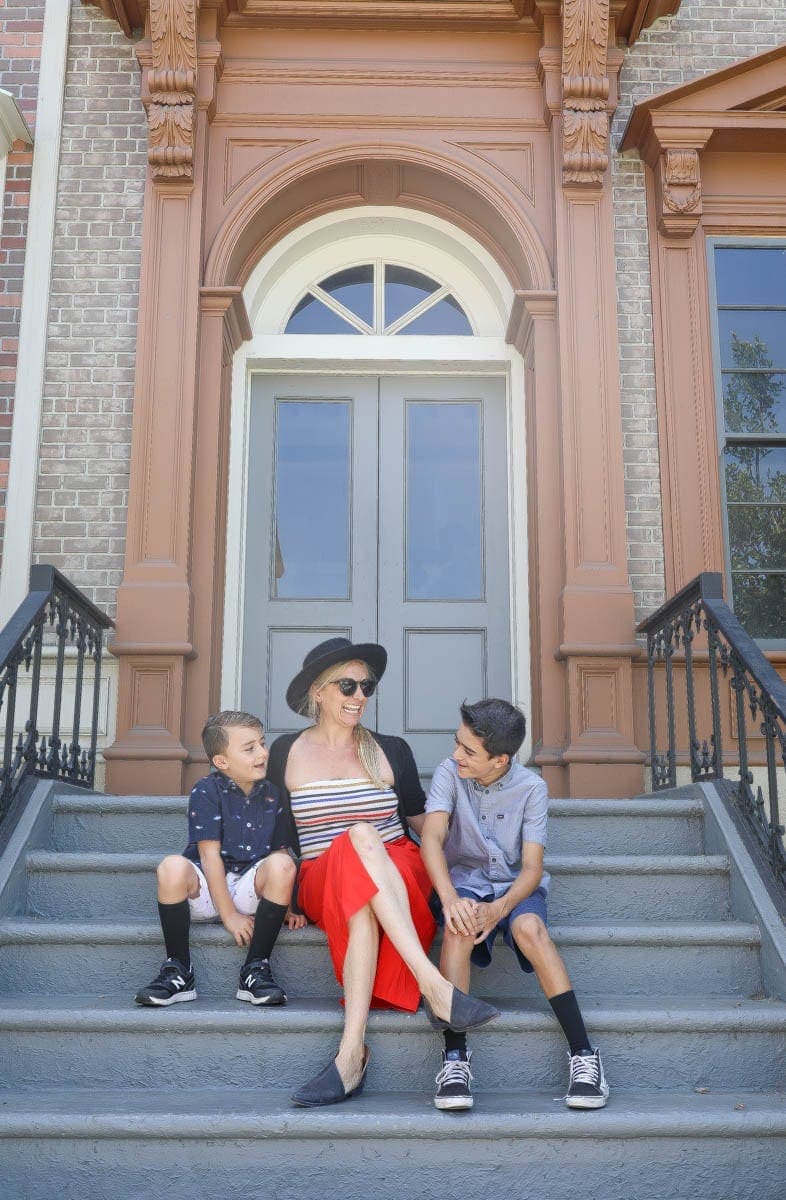 Happy Mom Sitting on the Stairs with her Kids #hollywood #warnerbrothers #teentitansgotothemovies #citygirlgonemom