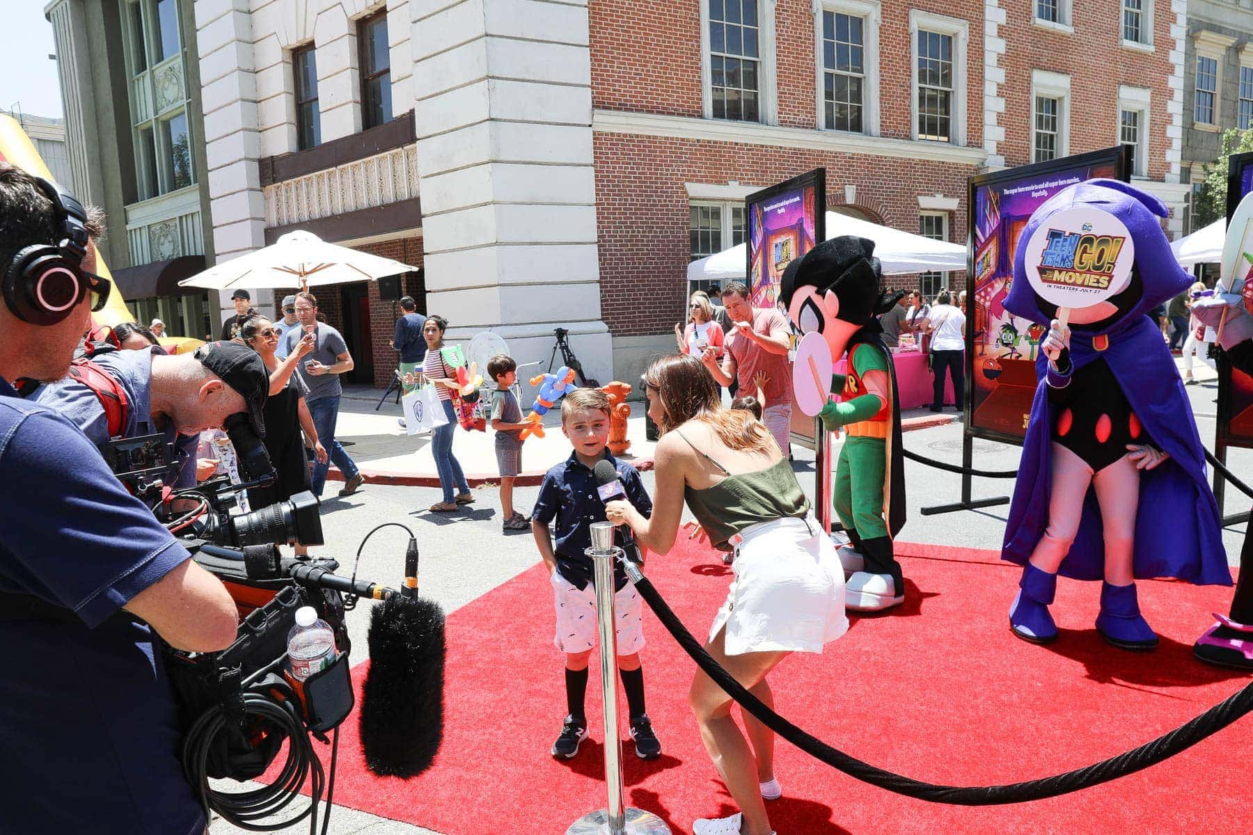 Lady Interviewing a Boy with Cameramen and Mascots #hollywood #warnerbrothers #teentitansgotothemovies #citygirlgonemom