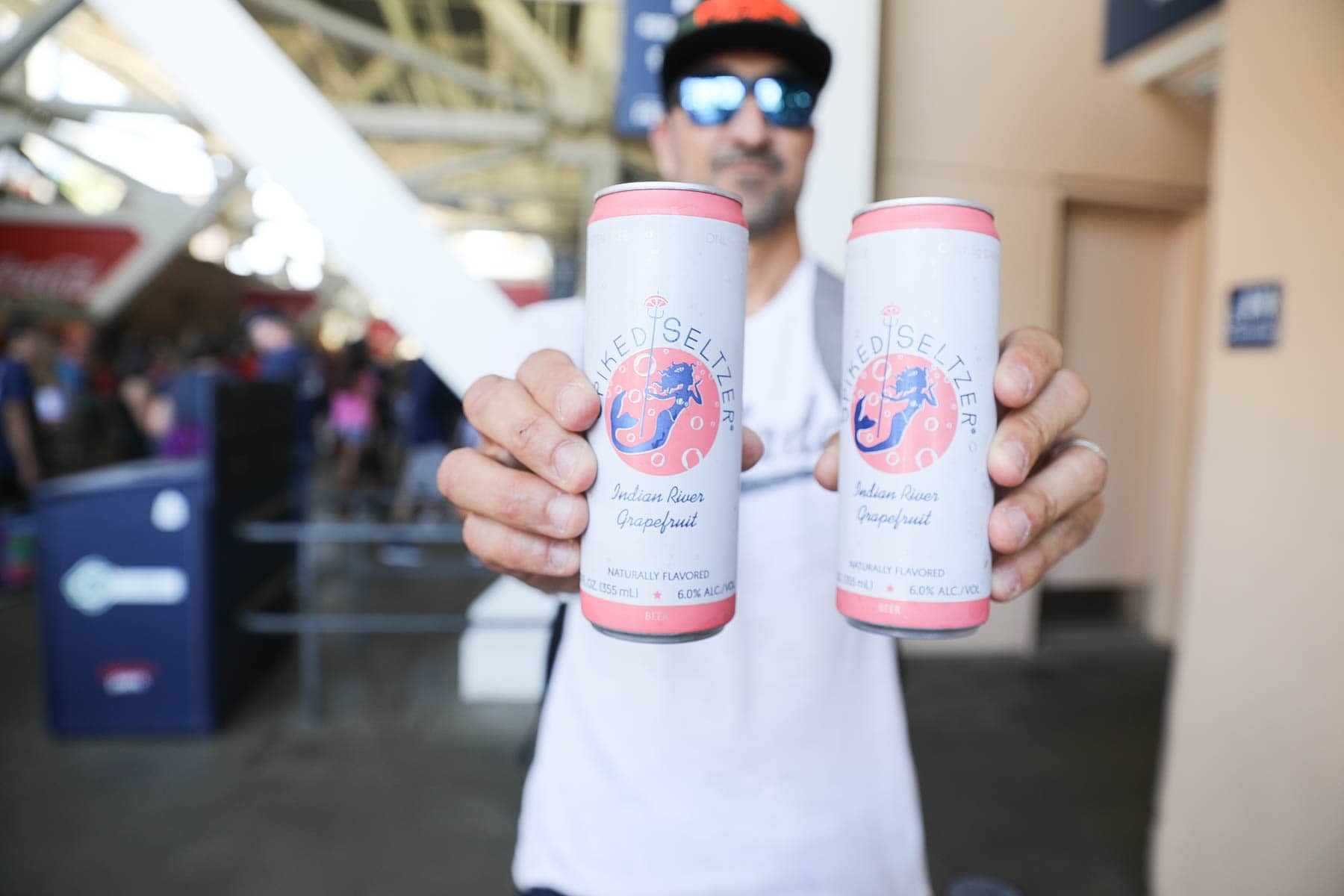 Man Holding 2 cans of Spiked Seltzer® Indian River Grapefruit #familyday #family #weekend #familydaysout #citygirlgonemom #spikedseltzer