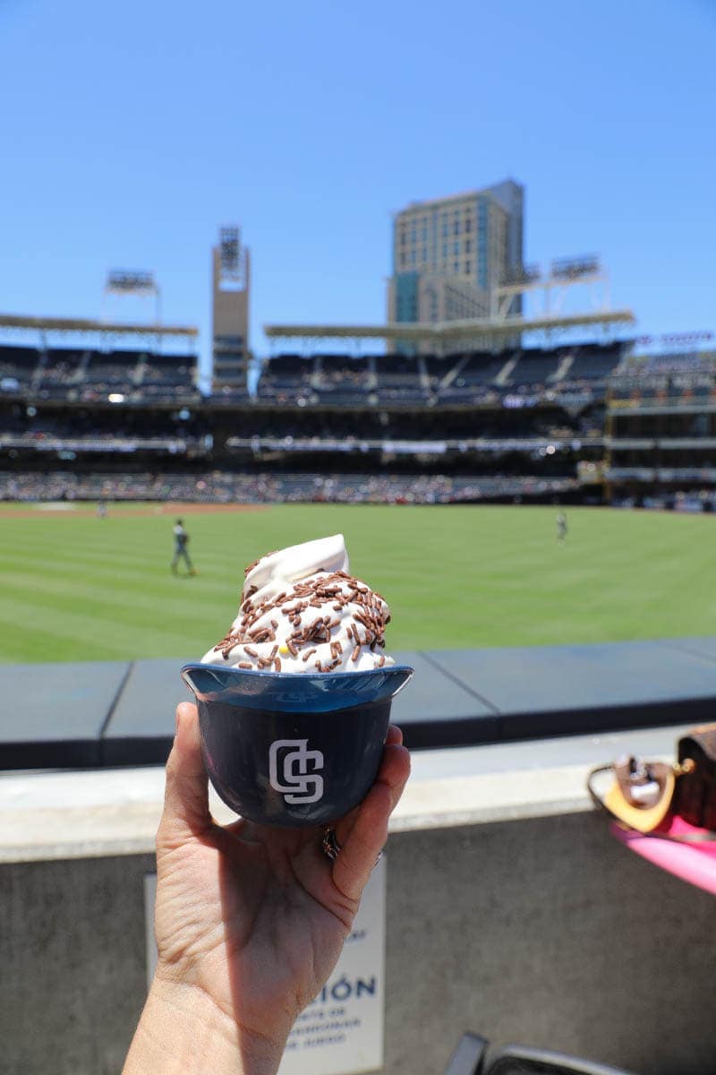 Ice Cream in a hand with a Baseball Stadium Background #familyday #family #weekend #familydaysout #citygirlgonemom #icecream 