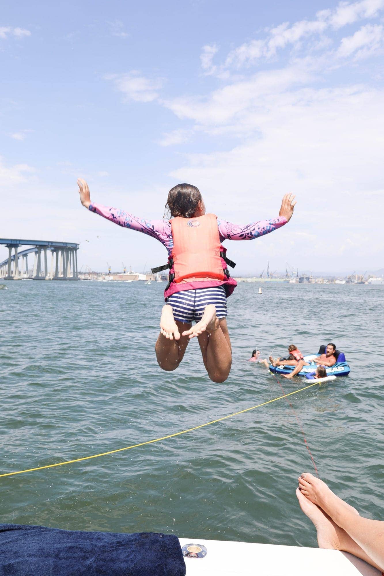 girl jumping off boat