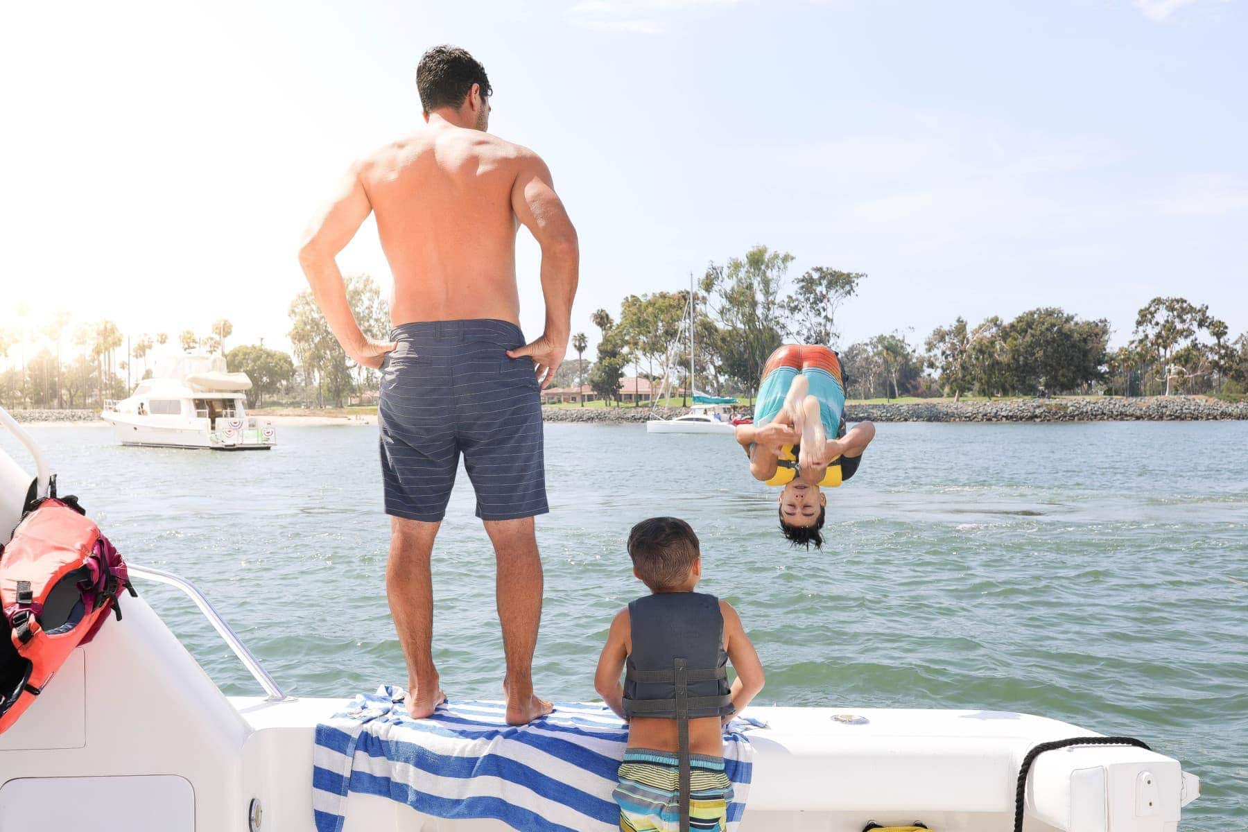 boys jumping off boat