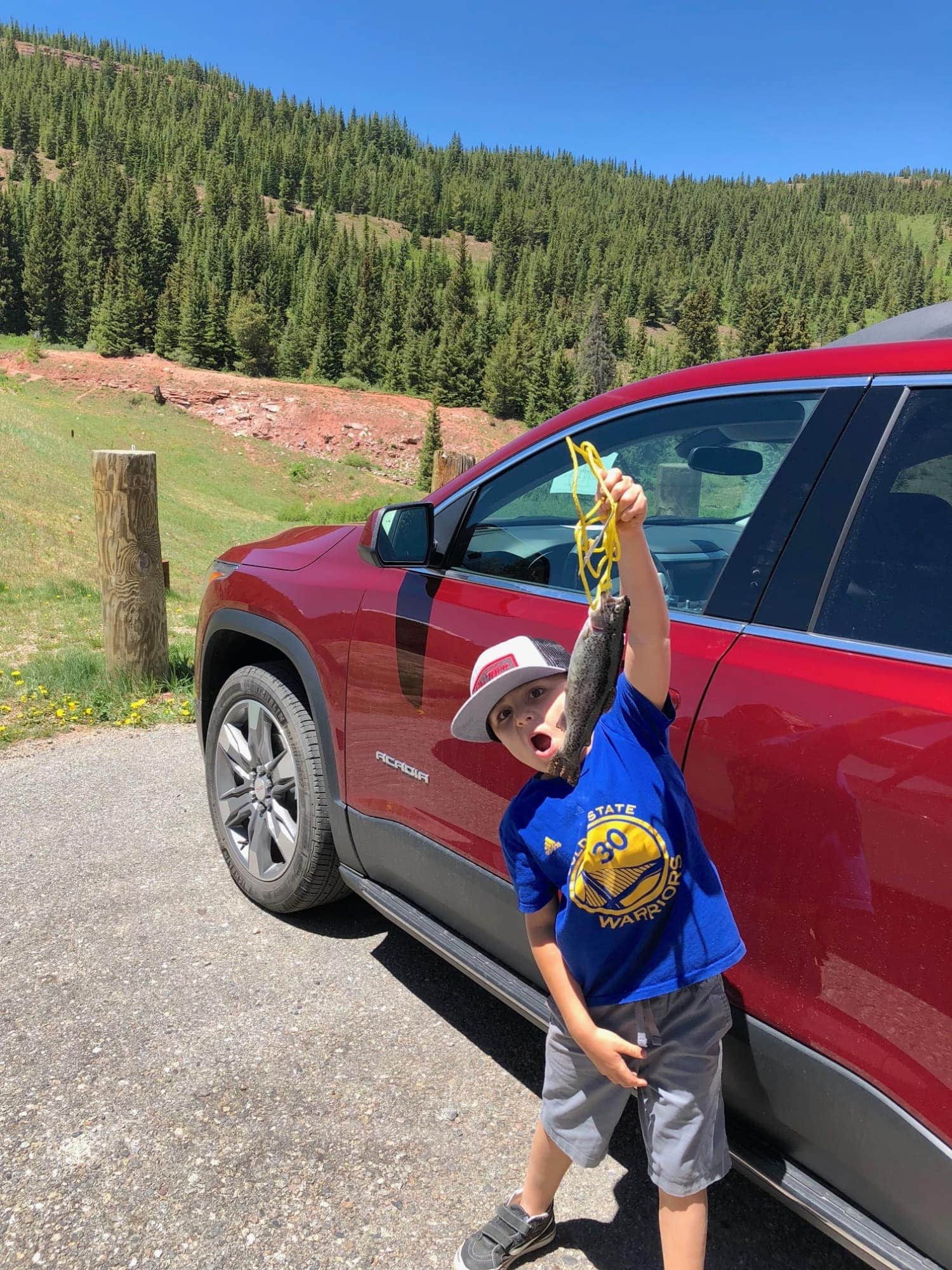 boy fishing GMC Acadia