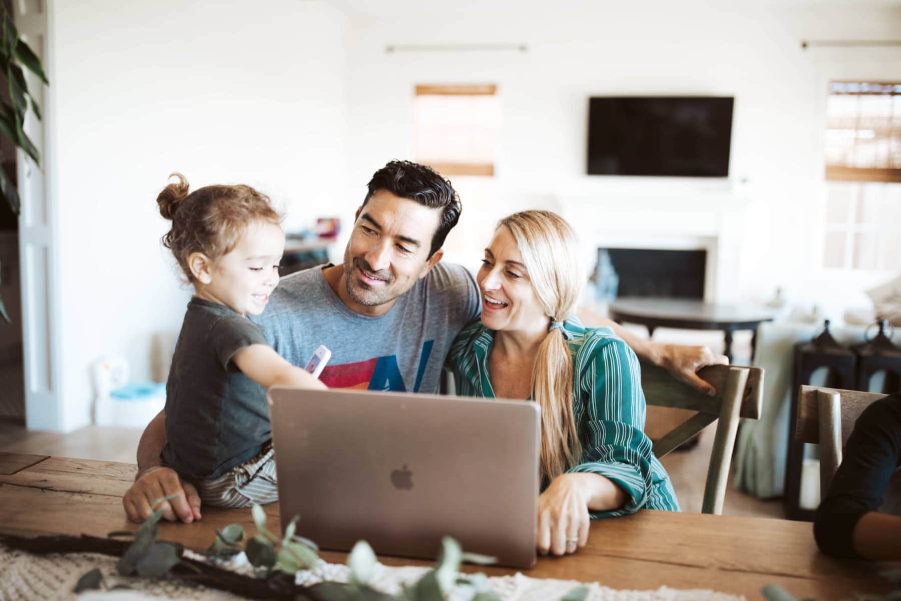 parents and baby with laptop