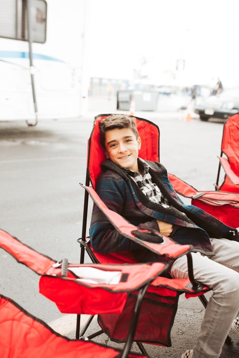 boy sitting at tailgate 